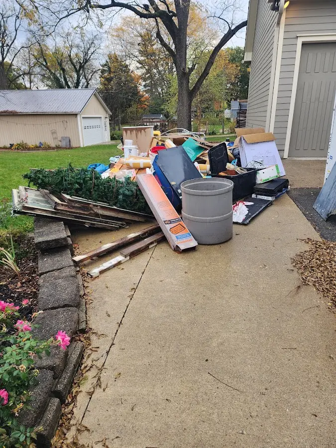 Dumpster being loaded with debris for Residential Dumpster Rental in Mountain Brook